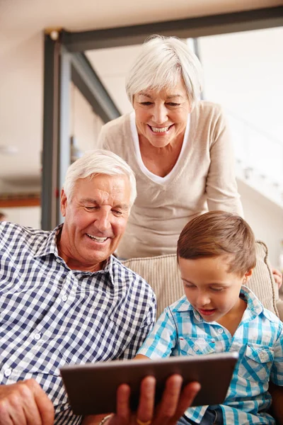Online entertainment for young and old. a young boy with his grandparents