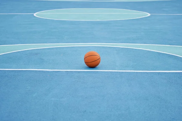 Basketball sport ball in empty basketball court to play, train and practice for tournament game and training day. Summer sports exercise and fitness workout training or practicing for competition.