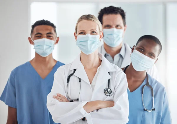 Covid 19, face mask and woman doctor with nurses teamwork in hospital compliance in stop of global virus. Healthcare leadership, medical and diversity collaboration in security wellness medicine room.