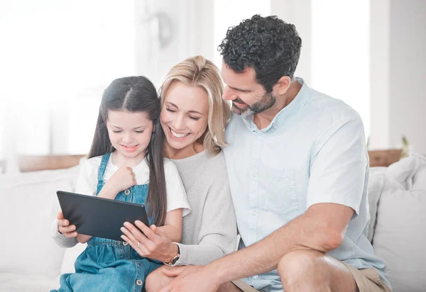 Education, learning and girl with parents and tablet for cartoon, movie or video on the web. Social media, connection and mother and father with an app on technology and child in their family home.