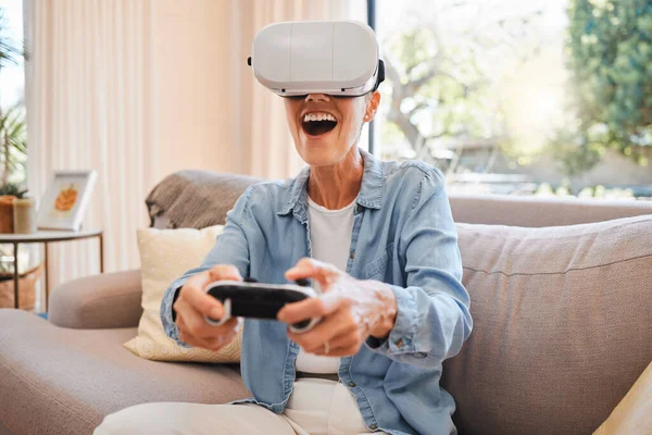 VR, metaverse and 3d gaming with a woman playing a video game on a sofa in the living room of her home. Virtual reality, esports and technology with a female gamer enjoying an online experience.