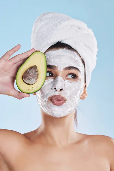 Beauty, skincare and avocado face mask with a beautiful woman taking care of her clean and healthy skin. Organic, fresh and cleansing facial with routine spa treatment with natural ingredients.