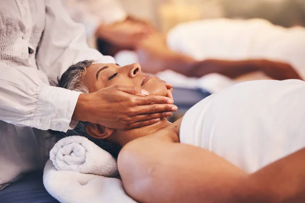 Spa, facial and massage of senior woman for peace, relaxation and wellness procedure lifestyle. Health, physical therapy and masseuse at luxury resort massaging client on salon treatment bed