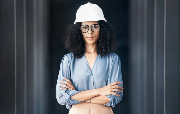Architecture, engineering and black woman leader portrait at construction site, industrial building or property development. Pride, vision and motivation of female contractor manager in safety helmet.