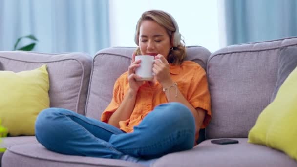 소파에 아시아 긴장을 커피와 헤드폰 집에서 행복을 스트리밍하는 헤드셋을 캐스트 — 비디오