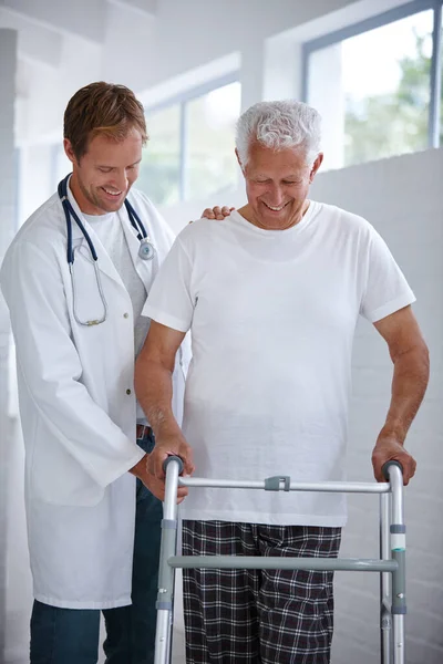 Youll be walking around in no time. a male doctor assisting his senior patient whos using a walker for support