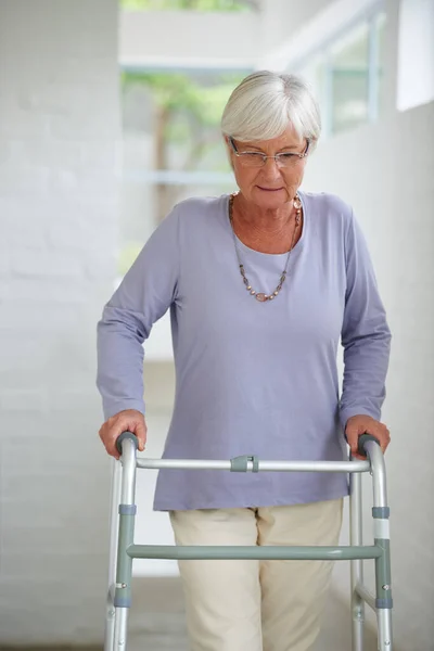 stock image Get the support you need when you need it. a senior woman walking carefully with the help of a walker