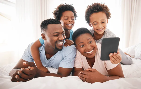 Happy, selfie and relax with black family in bedroom for bonding, social media and connection. Wake up, morning and affectionate with parents and children at home for weekend, picture and happiness.