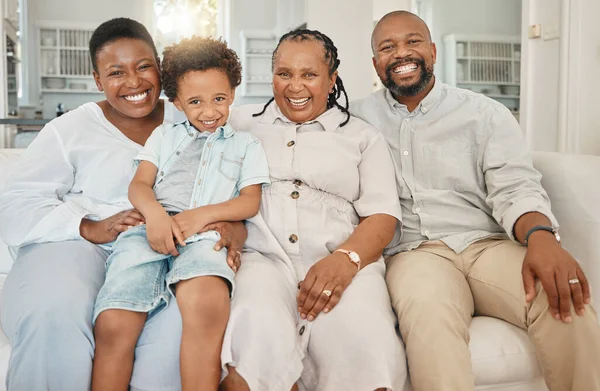 Happy, smile and portrait of a black family on a sofa relaxing, resting or bonding together. Happiness, love and African boy child sitting with his mother and grandparents on a couch in living room