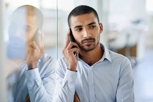 stock image Im listening. a handsome young businessman talking on his cellphone in the office