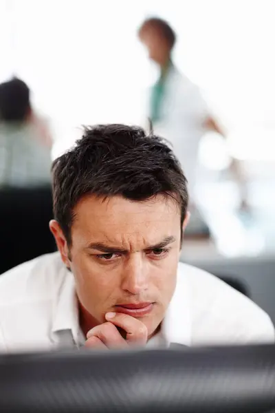 stock image Thinking long and hard. A young businessman looking thoughtful in the office