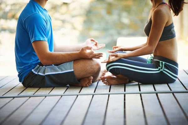 stock image Feeling at peace. Cropped view of a two people doing yoga face to face