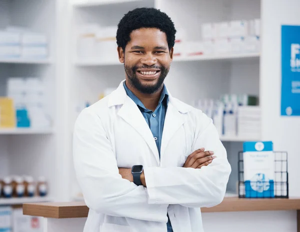 Pharmacist, black man or arms crossed in portrait, medicine trust or about us healthcare in medical insurance drugstore. Smile, happy or confident pharmacy worker in retail leadership or consulting.