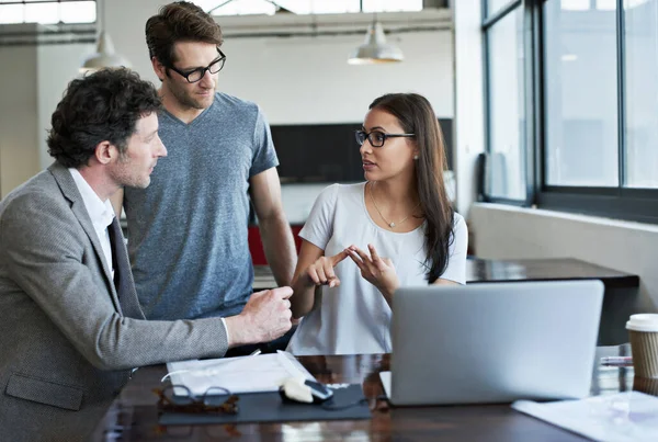 stock image So these are my ideas...three businesspeople in the office