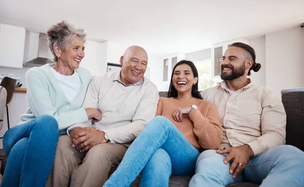 Portrait, happy family and relax on a sofa, laughing and bonding in a living room together. Seniors, retirement and weekend visit by man and woman with mature parents, carefree and fun at home.