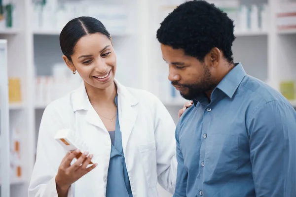 Pharmacy, medicine and pills, pharmacist and customer, health and prescription medication and people in drug store. Medical, pharmaceutical product box and black man with woman, advice and treatment.