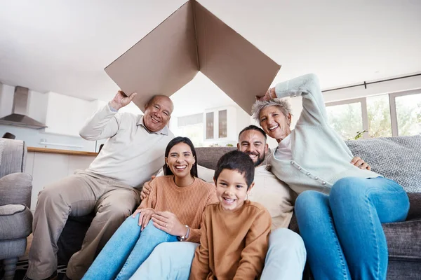 Senior family, cardboard roof and portrait in moving, real estate investment or home insurance of senior people and kid. People or parents and children with box for property, house or mortgage cover.