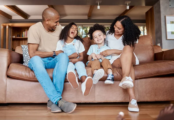Black family, living room sofa and bonding of a mother, father and kids on a couch with happiness. Happy, parent love and support of girl kids laughing in a home together with a smile in a home.