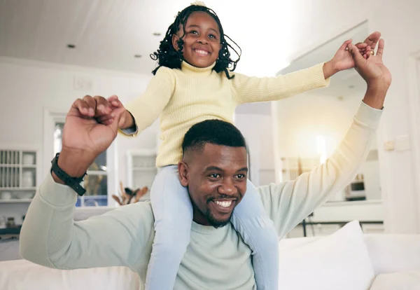 Black family, home and dad having fun with a child on a living room sofa with happiness. Father bonding, parent love and support of a kid with a smile and father in a house with lens flare in lounge.