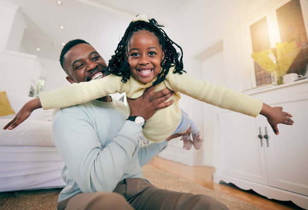 Black man, father and daughter with plane game, happiness and smile for love, bonding and care on bedroom floor. Happy family home, airplane games and dad with holding, balance and happy with playing.