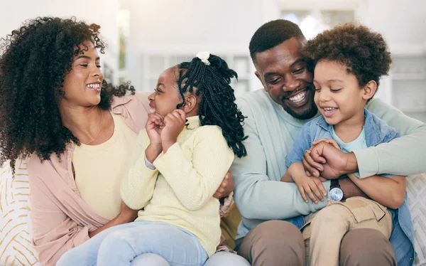 Happy, love and black family bonding on the sofa together in the living room of their modern home. Happiness, smile and African children having fun with parents while sitting on the couch at house