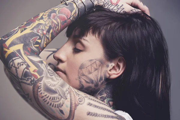 Intricate body art. A cropped studio portrait of a tattooed young woman