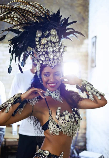 Natural born performer. an attractive ethnic female dressed in traditional beaded Mardi Gras wear dancing the samba