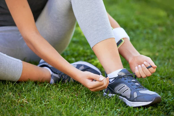 stock image Untied shoelaces wont stop her workout. a runner tying her shoelaces