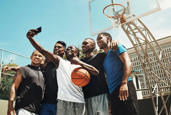 Basketball selfie, black people team for game, competition or outdoor social media post update on blue sky mock up. Influencer sports group of men using phone or cellphone for portrait digital memory.