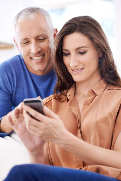 stock image Home is wherever the love is. a happy couple reading text messages together