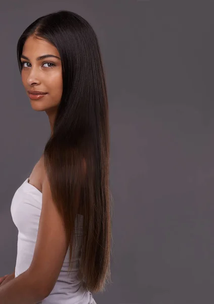 Showing Her Luscious Locks Portrait Beautiful Young Woman Posing Studio  Stock Photo by ©PeopleImages.com 645348000