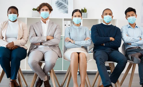 Recruitment during covid, hiring and diversity business people with mask for safety from corona virus pandemic. Portrait of group of people in waiting room for job interview with human resources hr.