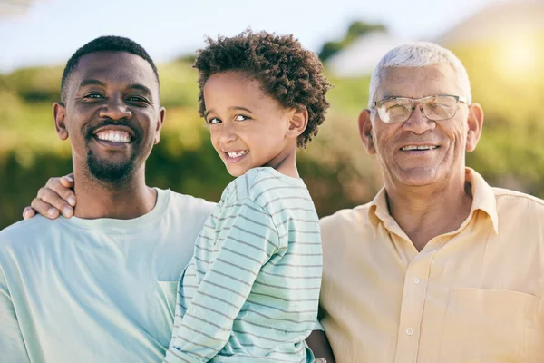 Portrait, black family with a father, son and grandfather bonding outdoor in the garden together for love. Happy, kids or generations with a man, boy and senior relative standing outisde in the yard.