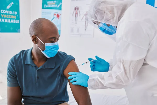 Covid vaccine, injection and disease cure given with needle and syringe by a doctor in a clinic. Patient getting a flu jab, antiviral shot and health treatment to boost immunity and prevent illness.