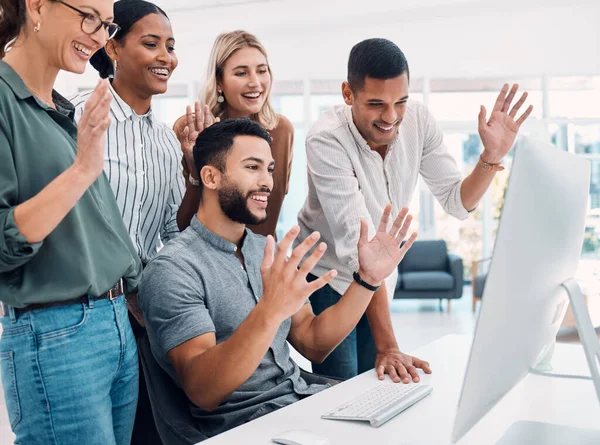 stock image Video conference, business and employees with wave while talking on a computer together at work. Happy, corporate and young group of marketing employees greeting on a webinar on a pc in an office.