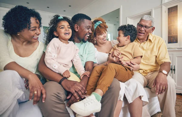 Black family laughing, portrait and living room sofa of a mother, father and children with grandparent. Happy, smile and bonding of a mom, dad and young kids together having fun with love and support.