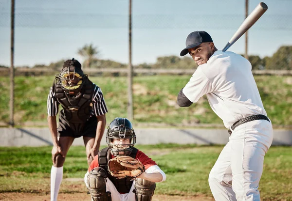Baseball, bat and catch with a sports man outdoor, playing a competitive game during summer. Fitness, health and exercise with a male athlete or player training on a field for sport or recreation.