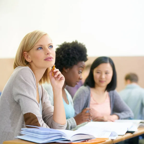 stock image Thinking of the weekend...female university students sitting in an exam room
