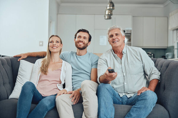 Watching tv, family and home of a couple with grandparent streaming a movie happy on a sofa. Television, living room and video watching of people on a family home couch with technology and happiness.