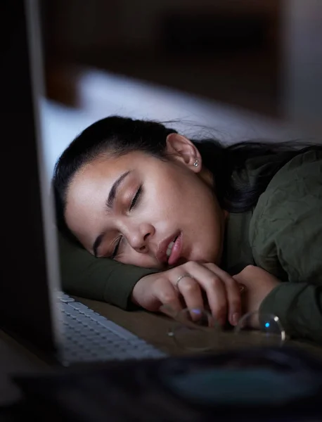 stock image Exhausted, night and a business woman sleeping at her desk while working overtime in her office. Burnout, deadline and tired with a female employee asleep in the workplace during the late shift.