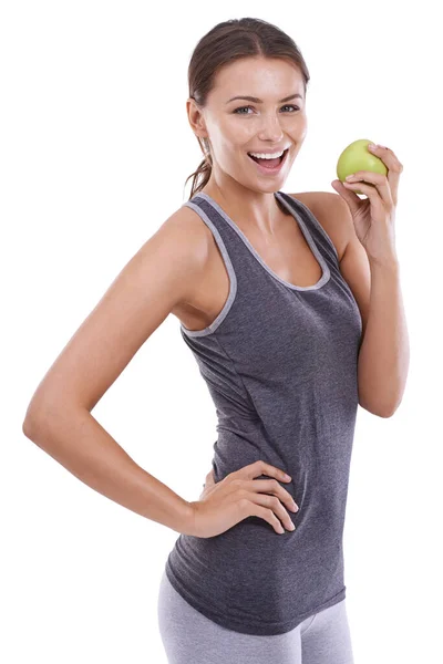 健康的な選択をする 体操着を着た若い女性がリンゴを持ってカメラで微笑んだ — ストック写真