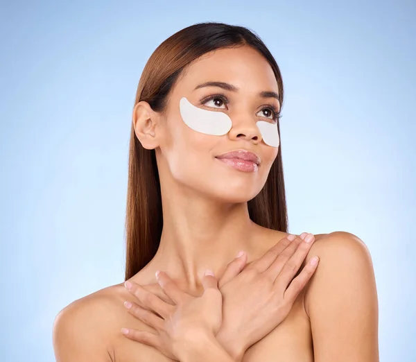 stock image Skincare, collagen and woman with eye mask for anti aging beauty routine on blue background mockup. Cosmetics, facial repair and face of hispanic model with detox treatment product in studio promo