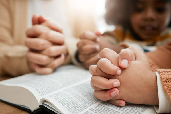 Bible, praying or hands of woman with children siblings for worship, support or hope in Christianity. Kids education, prayer or mother studying, reading book or learning God gospel in religion blur.