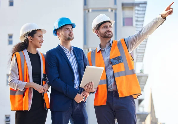 Architecture people pointing for outdoor planning, teamwork or collaboration at building construction site or development. Engineering, property and business contractor or industry person with group.