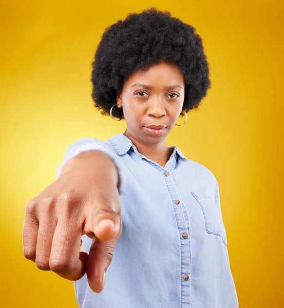 Hand, pointing and portrait of black woman in studio for you, choice or deciding on yellow background. Face, emoji and finger of suspicious lady with warning, guilty or blame, sign or accountability.