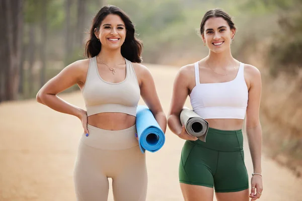 stock image Fitness, portrait or women friends in nature for yoga exercise to start workout or body training. Healthy athlete girls smile, relaxed or happy people ready for outdoor exercising together with mat.