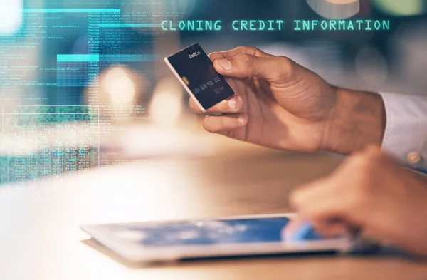 Hands, tablet and credit card hacking bank information, cloning or cybersecurity at night on office desk. Hand of hacker stealing banking data, app or identity in fraud or online theft at workplace.