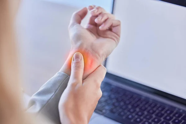 Business woman, wrist injury and red pain from osteoporosis, orthopedic joint and laptop typing in office. Worker, carpal tunnel and hands of health risk, arthritis and muscle fatigue of fibromyalgia.