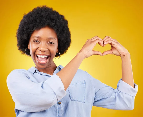 Love, heart hands and portrait of black woman, smile and kindness isolated on yellow background. Motivation, support and loving hand gesture, like sign or emoji, happy African model in studio mockup