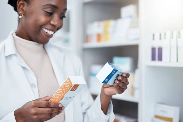 Black woman, pharmacist and choice with box, medicine and decision with prescription for healthcare. Pharmacy, drugs and pharmaceutical pills for health, wellness or medical store with stock on shelf.